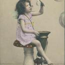 Vintage postcard, tinted photo of a little girl with bubbles