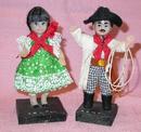 PAIR OF LATIN LOOKING DOLLS ON WOOD STANDS