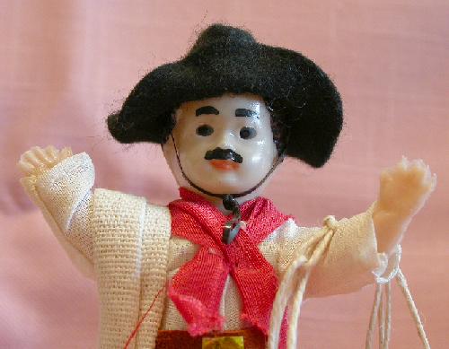 PAIR OF LATIN LOOKING DOLLS ON WOOD STANDS