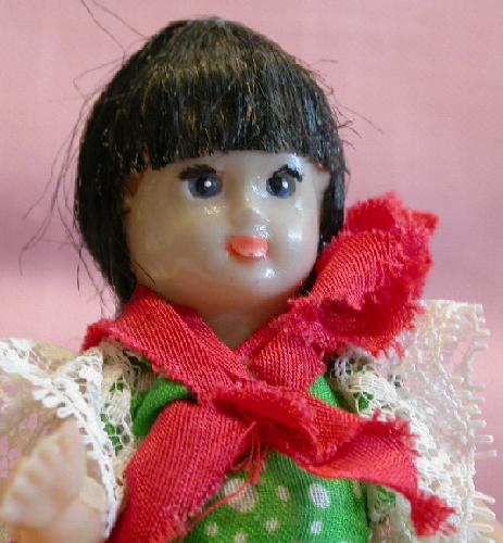 PAIR OF LATIN LOOKING DOLLS ON WOOD STANDS