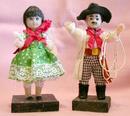 PAIR OF LATIN LOOKING DOLLS ON WOOD STANDS