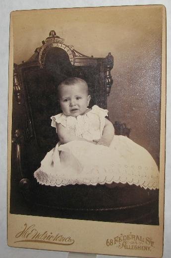 UNHAPPY BABY IN GREAT VICTORIAN CHAIR