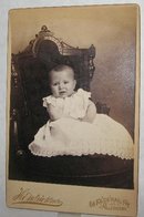 UNHAPPY BABY IN GREAT VICTORIAN CHAIR