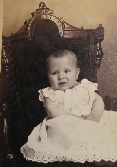 UNHAPPY BABY IN GREAT VICTORIAN CHAIR