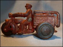 ANTIQUE CAST IRON RED CRASH CAR HARLEY WITH DRIVER AND CRASH CART