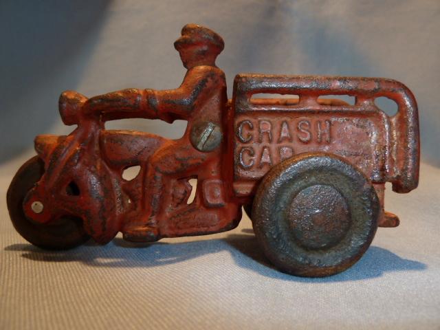 ANTIQUE CAST IRON RED CRASH CAR HARLEY WITH DRIVER AND CRASH CART