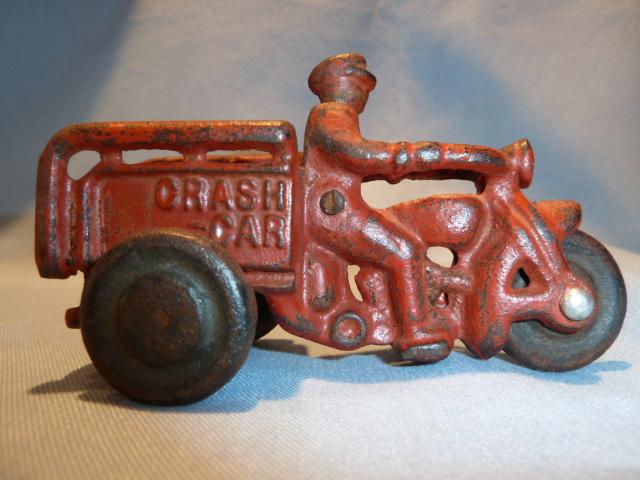 ANTIQUE CAST IRON RED CRASH CAR HARLEY WITH DRIVER AND CRASH CART