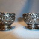 F.B. ROGERS PAIR OF SILVER PLATE ORNATE SALTS WITH COBALT LINERS