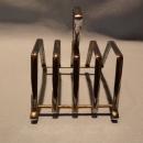 TWO MIDWINTER TOAST DISHES WITH ONE CHROME CENTER RACK THAT CAN BE USED ON EITHER TOAST
