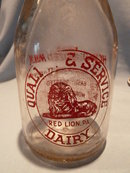 VINTAGE QUALITY AND SERVICE DAIRY RED LION, PA RED PYRO ROUND QUART BOTTLE
