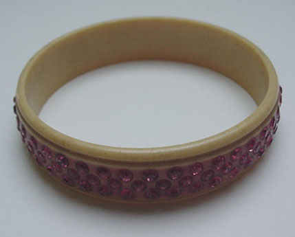 Celluloid bangle with pink rhinestones
