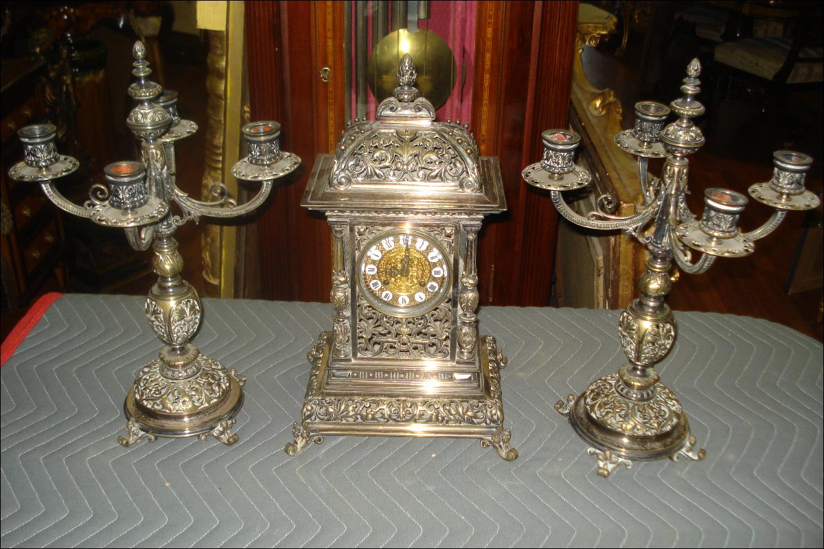 Nineteenth Century French Theree Piece Clock Set Silver Over Bronze, Pierced In The Moorish Orientalist Style, With Matching Candelabra