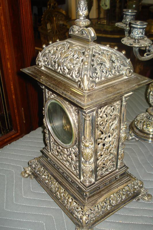 Nineteenth Century French Theree Piece Clock Set Silver Over Bronze, Pierced In The Moorish Orientalist Style, With Matching Candelabra