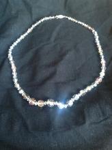 A classy string of silver-toned crystal beaded necklace