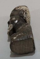Carved stone bookend of Tribal man