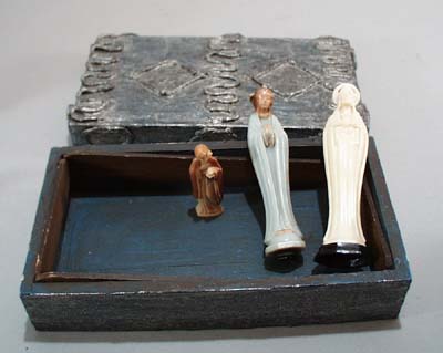 Wooden box holding 3 little statues of Christ and Mary