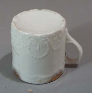 Old porcelain mug with great unusual pattern in porcelain.