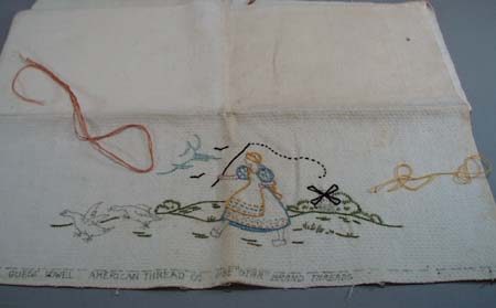 Dishtowel with dutch girl chasing geese.