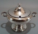 Covered small tureen with spoon opening.