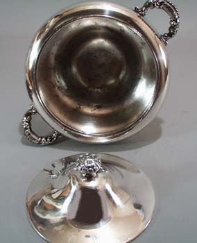 Covered small tureen with spoon opening.