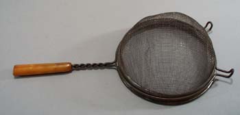 Yellow/brown bakelite handle strainer
