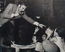 Picture of Elvis With Mike and Pointing to Fan 1956