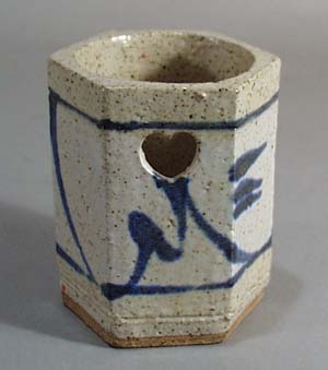 Stoneware candle holder with punched out star shapes