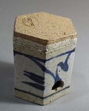 Stoneware candle holder with punched out star shapes