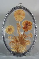 Leaded glass suncatcher with real pansy inside.