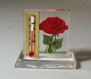 Lucite holder Thermometer with red rose.