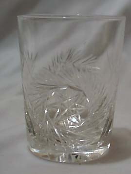 Cut glass tumbler with starburst design.