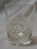 Cut glass tumbler with starburst design.