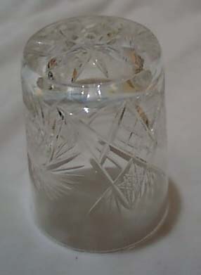 Cut glass tumbler with starburst design.