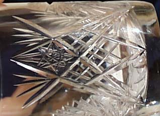 Cut glass tumbler with starburst design.