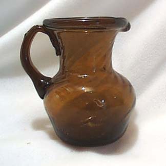 Hand blown dk amber creamer or mini pitcher.
