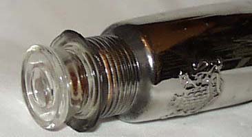 Mercury glass bottle, has crest on the front.