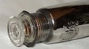 Mercury glass bottle, has crest on the front.