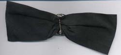 Black ribbon bow with rhinestone pin. Pin is