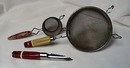 3 red handled utensils