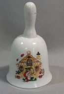 Mouse sitting by gingerbread house bell