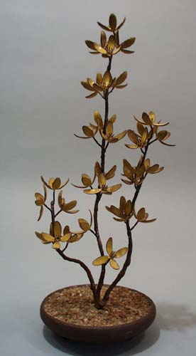 Bovaro of Chestshire Maine yellow flowers tree statue