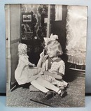 1910 photo girl talks to doll