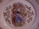 Porcelain Display Plate Featuring Lady In Tree With Basket of Pink Flowers