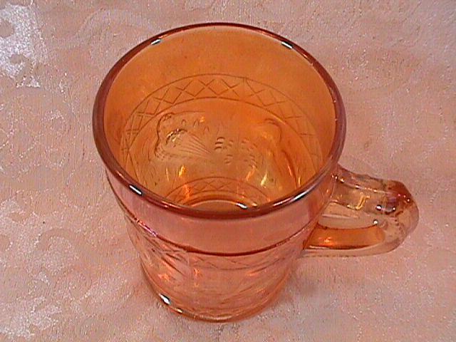 CARNIVAL GLASS STORK and RUSHES MUG MARIGOLD
