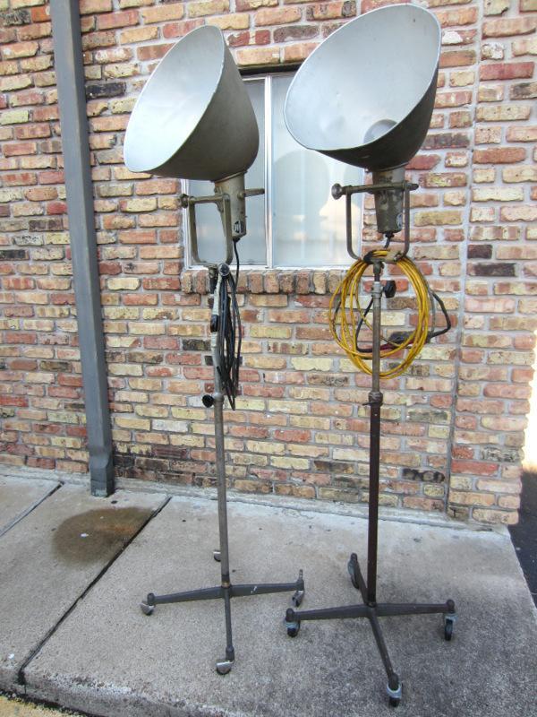 VERY RARE! PAIR OF VINTAGE PHOTOGENIC MACHINE CO. INDUSTRIAL MACHINE AGE STEAM PUNK MID-CENTURY MODERN ADJUSTABLE FLOOR LAMPS FLOODLIGHTS MODEL LIGHT ON IRON WHEEL BASE CASTERS