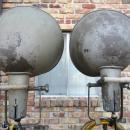 VERY RARE! PAIR OF VINTAGE PHOTOGENIC MACHINE CO. INDUSTRIAL MACHINE AGE STEAM PUNK MID-CENTURY MODERN ADJUSTABLE FLOOR LAMPS FLOODLIGHTS MODEL LIGHT ON IRON WHEEL BASE CASTERS