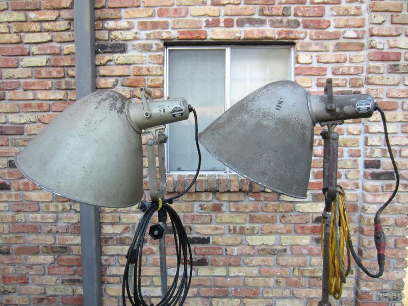 VERY RARE! PAIR OF VINTAGE PHOTOGENIC MACHINE CO. INDUSTRIAL MACHINE AGE STEAM PUNK MID-CENTURY MODERN ADJUSTABLE FLOOR LAMPS FLOODLIGHTS MODEL LIGHT ON IRON WHEEL BASE CASTERS