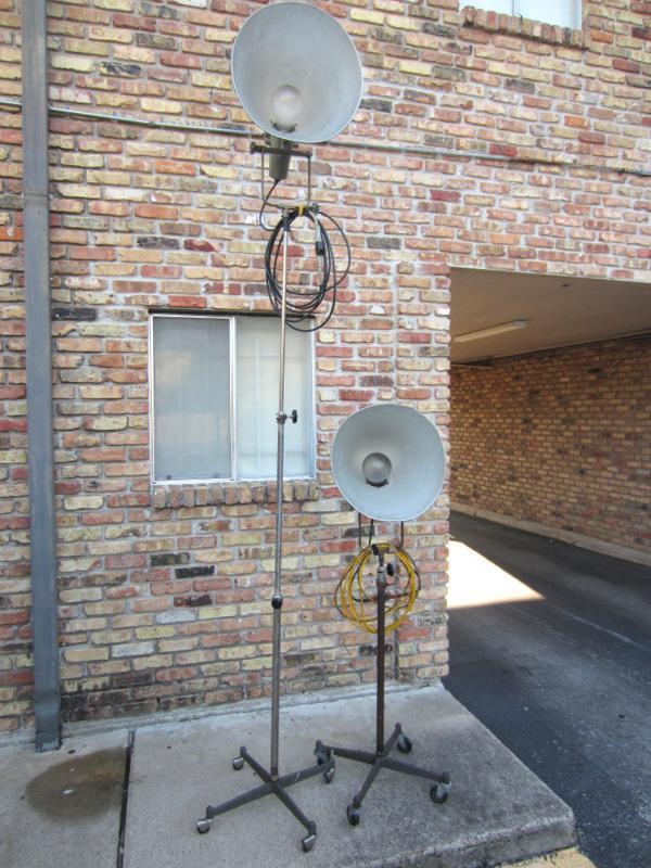 VERY RARE! PAIR OF VINTAGE PHOTOGENIC MACHINE CO. INDUSTRIAL MACHINE AGE STEAM PUNK MID-CENTURY MODERN ADJUSTABLE FLOOR LAMPS FLOODLIGHTS MODEL LIGHT ON IRON WHEEL BASE CASTERS