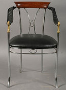 7401 Set of four chrome and bronze chairs, each having swan decorated arms and upholstered seats circa 1920.