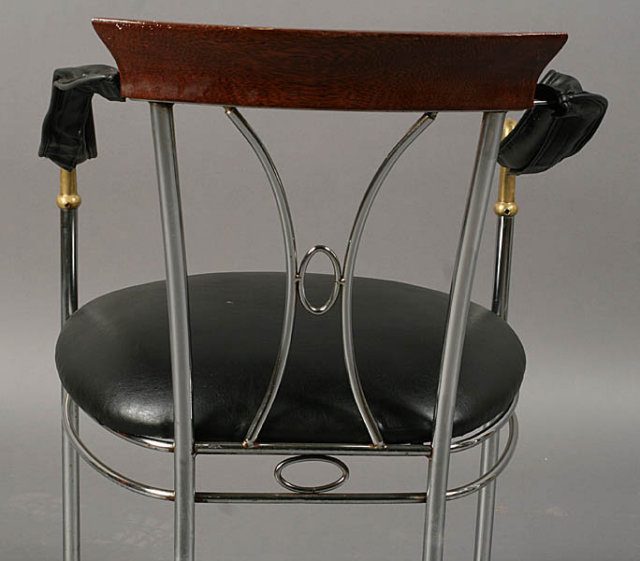 7401 Set of four chrome and bronze chairs, each having swan decorated arms and upholstered seats circa 1920.